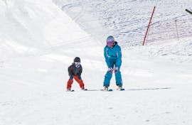 A ski instructor from the ski school ESI Snow Diam's is showing a young skiers the basics of skiing during a Private Ski Lessons for Kids - Crest-Voland.