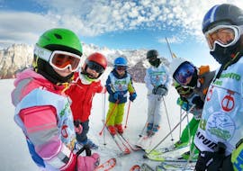 A group of young skier is ready to master the slopes during one of the Kids Ski Lessons (6-13 years) - All Levels organized by the ski school Scuola di Sci Pinzolo in the Val Rendena ski resort. 