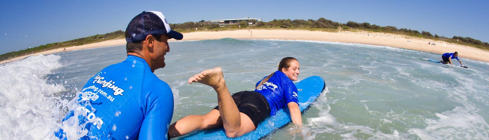 During the Surfing Lessons in Byron Bay for Teens & Adults - Beginner organised by a surf school Let's Go Surfing, a woman is learning how to surf.