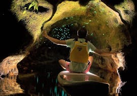 A boy is looking in awe the glow worms in a cave in the lake district of Rotorua during the Paddle Board Rotorua - Glow Worm Tour Winter organized by Paddle Board Rotorua.