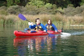 The participants paddle through the calm water and enjoy the view during the kayak rotorua guided hot pools - winter - lake rotoiti with River Rats Rotorua Raft & Kayak. 