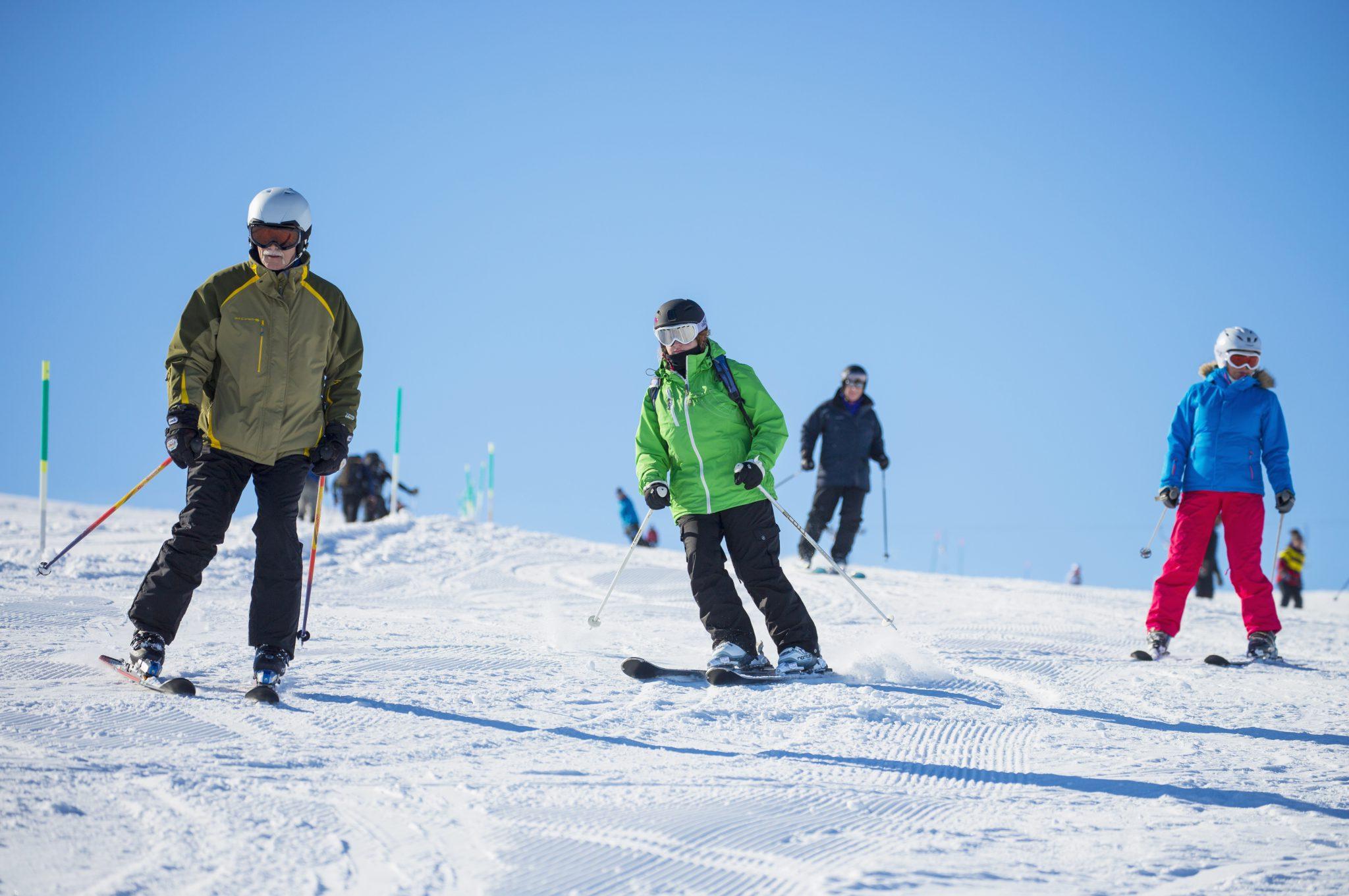 A group of skiers is practicing their turns on an easy slope during their Ski Lessons for Teens & Adults - All Levels with BigFutz Snow Sports School Zermatt.