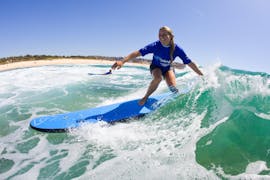 A woman is enjoying her first time on a surfboard during the Surfing Lessons in Maroubra for Teens & Adults - Beginner organised by Let's Go Surfing.