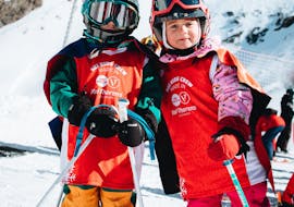 Two kids learn how to ski during their Kids Ski Lessons "Sifflote" (4 y.) with ESF Val Thorens.