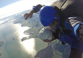 A tandem student and their instructor from Skydive Auckland are taking in the impressive bird's-eye view during their Tandem Skydive in Auckland - 13,000ft.