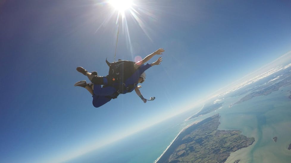 A tandem student and their instructor from Skydive Auckland are pictured while falling freely through the skies above the Auckland Region during their Tandem Skydive in Auckland - 13,000ft.