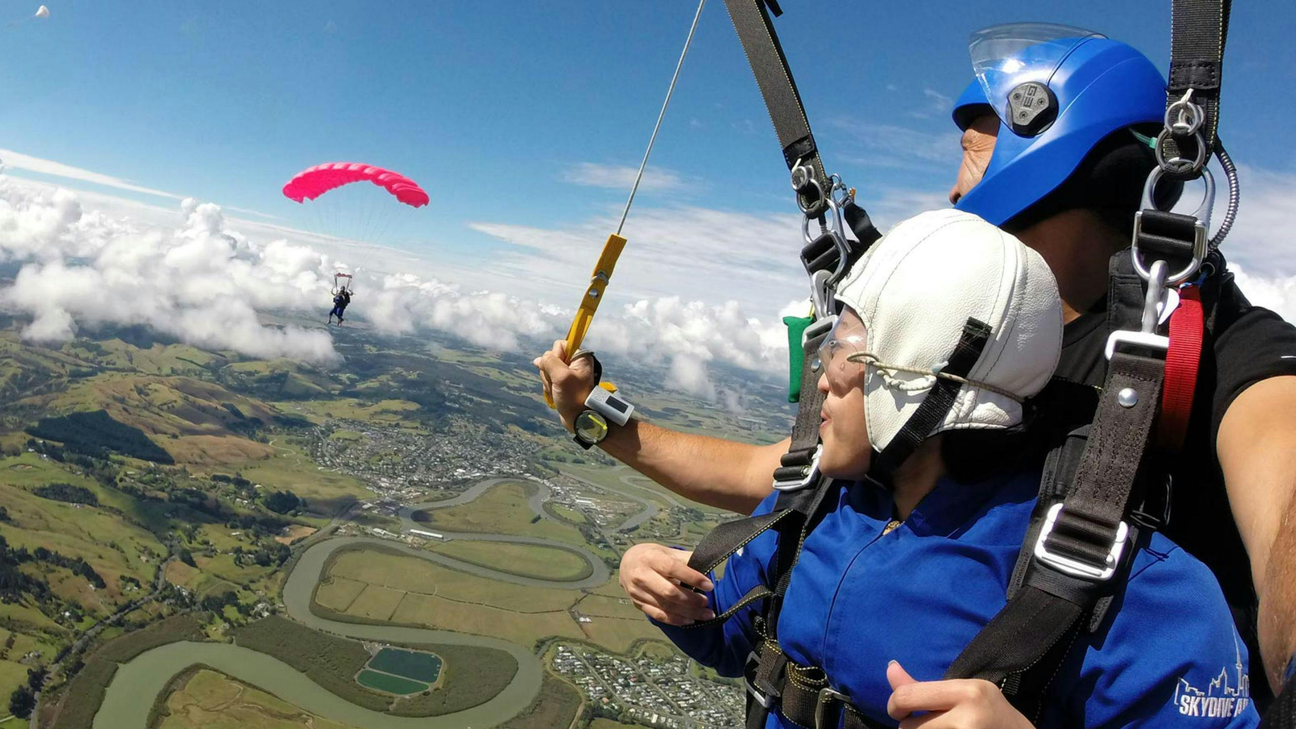 A female skydiver is filled with joy during her Tandem Skydive in Auckland - 9,000ft with Skydive Auckland.