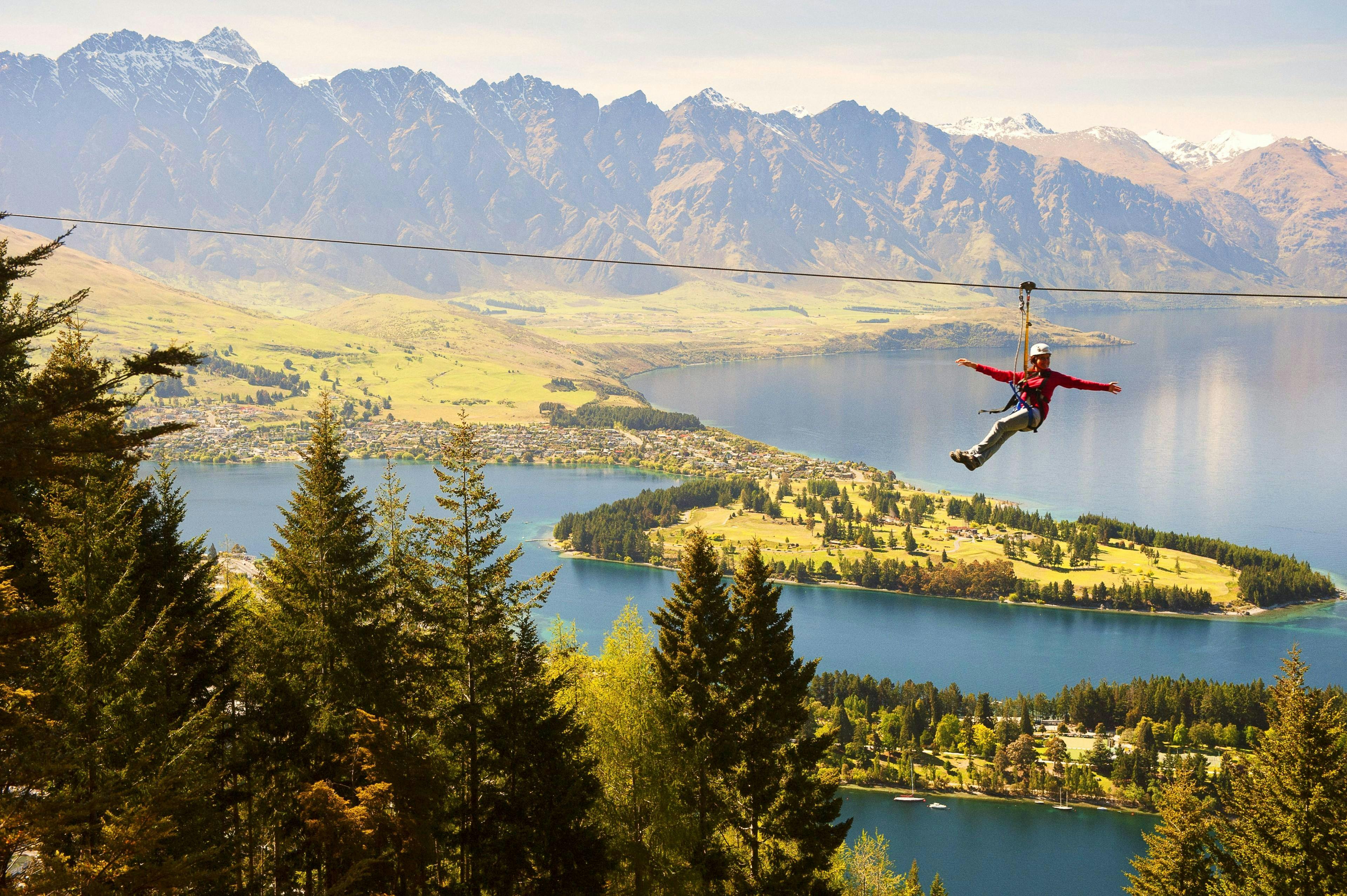 A child smiles at the photographer during the Zipline experience in Queenstown - Moa: 4 Lines offered by Ziptrek Ecotours Queenstown.