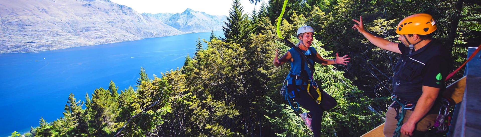 A girl looks at the difference in altitude below her, soon he will jump 21 m, which is the highlight of the Zipline route in Queenstown - Kereru: 2 Ziplines and 21 m Drop of Ziptrek Ecotours Queenstown.