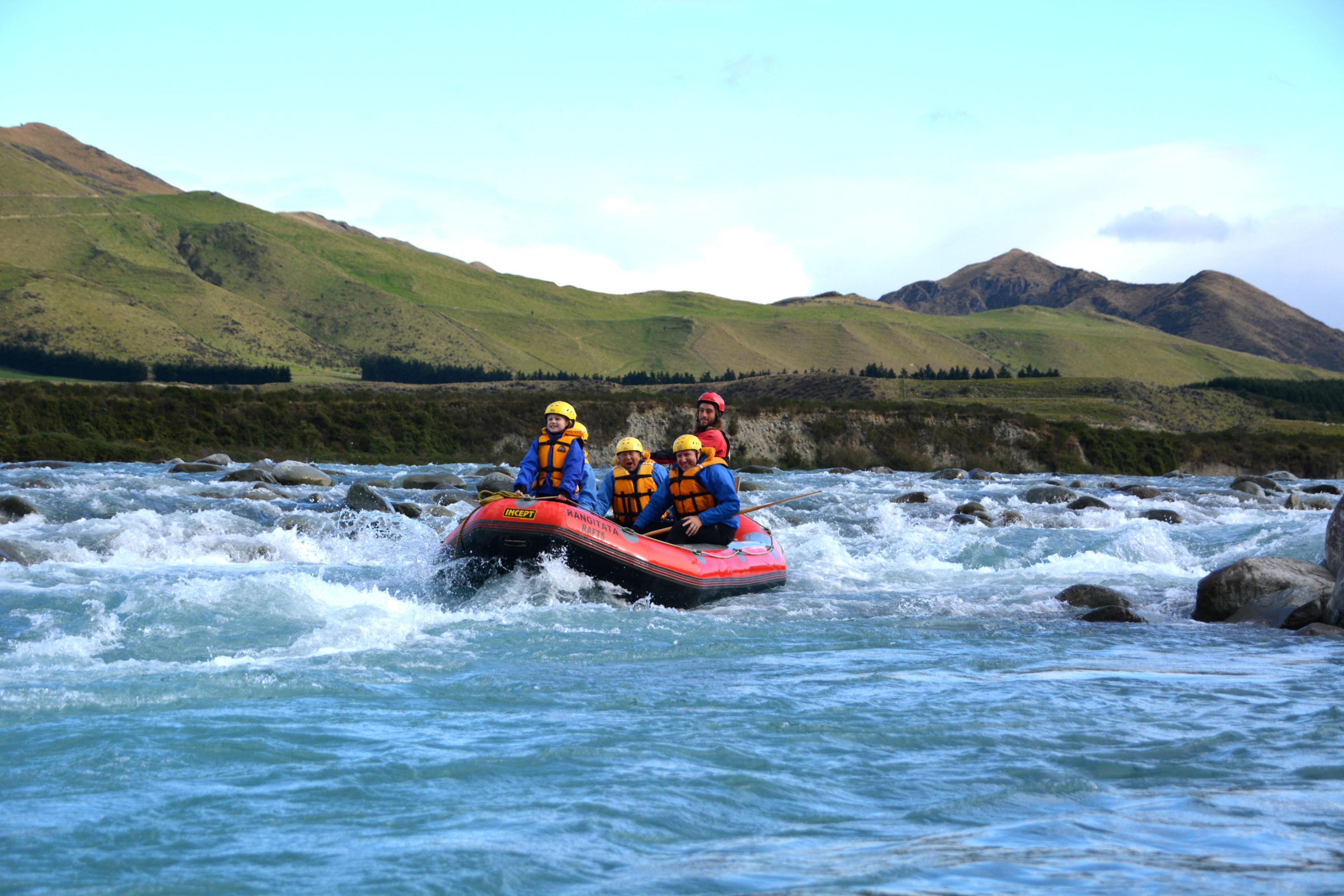 A family is having fun on the river during their Grade 2 Rafting Adventure on Lower Rangitata River organized by Rangitaiki Rafts.
