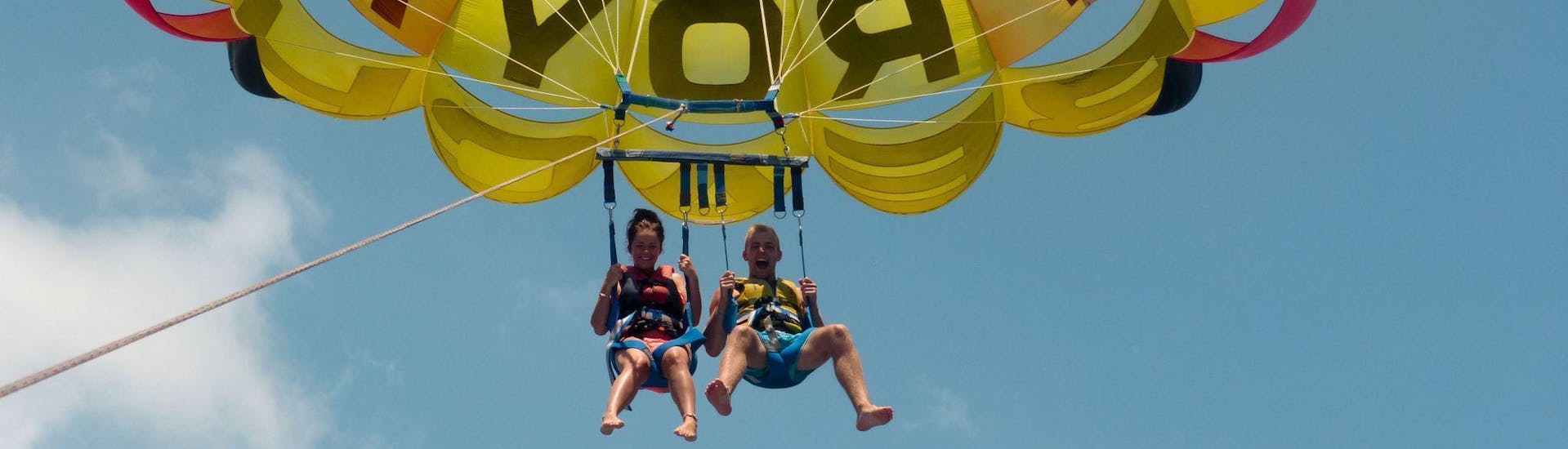 Two people from Watersports Tenerife parasailing in Tenerife .