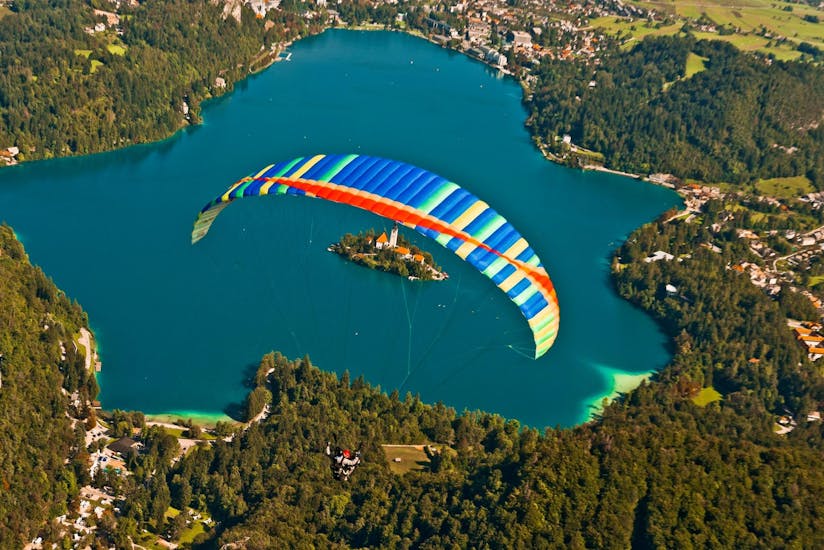 A participant enjoying a paragliding experience over Lake Bled during a paragliding activity with Fun Turist Bled.