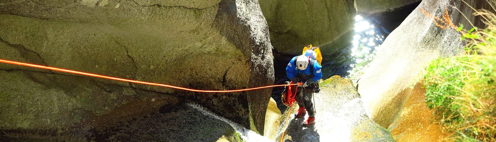 A man abseils in the sun during canyoning in the Sorba with Monterosa Canyoning.