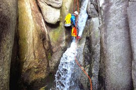 A guy abseils on a waterfall during canyoning in the Sorba with Monterosa Canyoning.