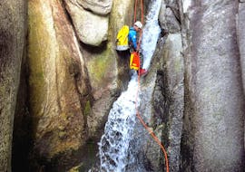 A guy abseils on a waterfall during canyoning in the Sorba with Monterosa Canyoning.