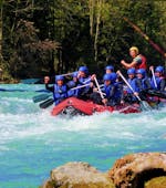 During their Half Day Rafting Tour on the Lech River with Fun Rafting Lechtal, the participants paddle over the splashing rapids of the Lech river.