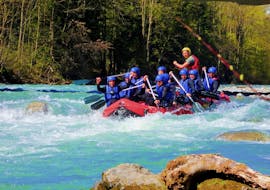 During their Half Day Rafting Tour on the Lech River with Fun Rafting Lechtal, the participants paddle over the splashing rapids of the Lech river.