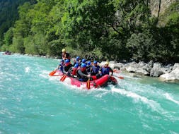 During their Rafting on the Lech River - Full Day Tour with BBQ Lunch with Fun Rafting Lechtal, a group of friends is having a great time while paddling along the turquoise Lech river.