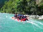 During their Rafting on the Lech River - Full Day Tour with BBQ Lunch with Fun Rafting Lechtal, a group of friends is having a great time while paddling along the turquoise Lech river.