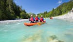 Three friends are paddling along the turquoise Lech river during their Canoe-Rafting on the Lech River - Half Day Tour with Fun Rafting Lechtal.