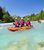 Three friends are paddling along the turquoise Lech river during their Canoe-Rafting on the Lech River - Half Day Tour with Fun Rafting Lechtal.