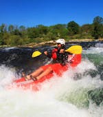 During the Rafting in a FUNYak on the Rhine - Wild Rhine with Rheinraft, a participant conquers a rapid in his agile, inflatable kayak.