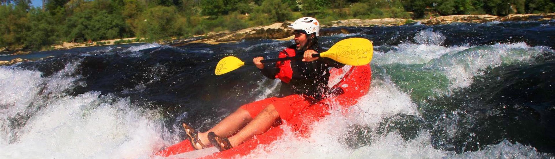 During the Rafting in a FUNYak on the Rhine - Wild Rhine with Rheinraft, a participant conquers a rapid in his agile, inflatable kayak.