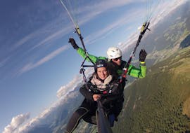 During the Tandem Paragliding over Campo Tures from Acereto with Tandemflights Kronplatz, a young woman is enjoying the view over the surrounding mountain scenery.