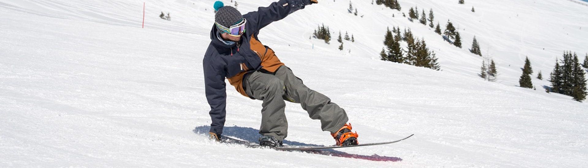 A snowboarder is practicing his tricks during his Freestyle Snowboarding Lessons "Package" - All Levels with BOARD.AT.