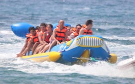 A group of friends let themselves be pulled by the boat through the sea during a Banana Boat in Salou organized by Nàutic Parc Costa Daurada.