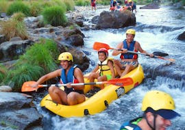 While Canoeing on Rio Paiva in Arouca Geopark with Clube do Paiva, a family of three is having fun as they paddle through a splashing rapid.