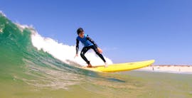 A young surfer is catching a good wave during the Intermediate Surf Lessons at Gamboa Beach in Peniche with Go4Surf Peniche.