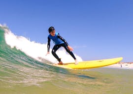 A young surfer is catching a good wave during the Intermediate Surf Lessons at Gamboa Beach in Peniche with Go4Surf Peniche.