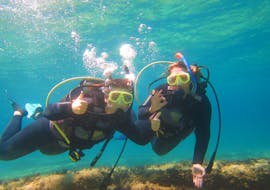 Two friends are exploring Corfu's underwater world during their CMAS* Scuba Diving Course for Beginners with Hercules Marine Activities Corfu.