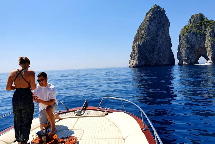 A man is proposing to his fiancé during the Private Boat Trip from Sorrento to Capri.