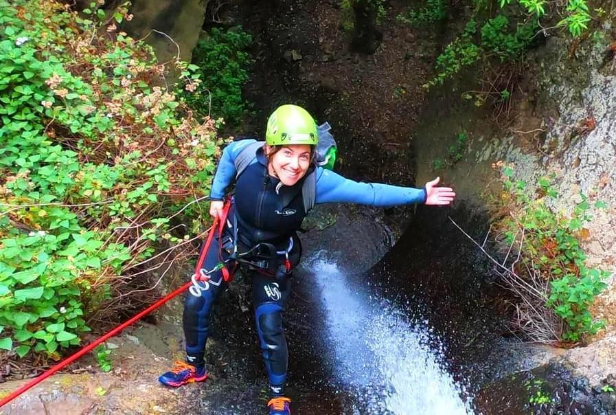The tour participants proudly climb down the gorge during Canyoning at Barranco de la Manta in Gran Canaria, organised by Mojo Picón Aventura.