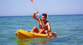 A young man is exploring the beautiful Algarve coast during his sea kayak rental at Praia de Armação de Pêra from Moments Watersports Algarve.