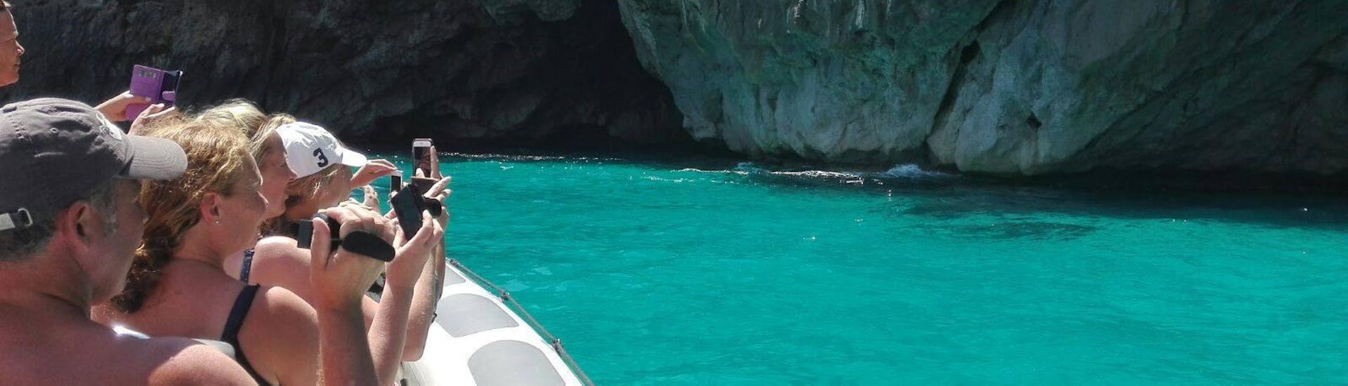 The tour participants enjoy the view of the crystal clear water and stone cliffs during the Boat Trip to Cabo Formentor with Dolphin Watching with Alcúdia Sea Explorer.