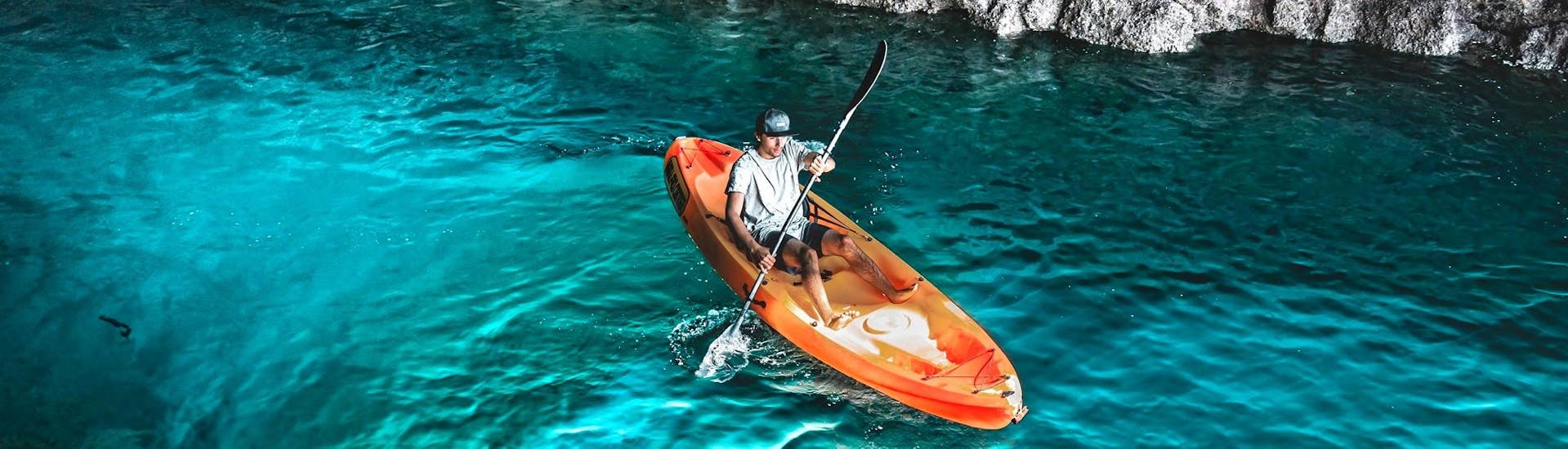 While Sea Kayaking in Arrábida Natural Park from Sesimbra wit Meira Pro Center Sesimbra, a participant is exploring the magical sea caves of the coast with his kayak.