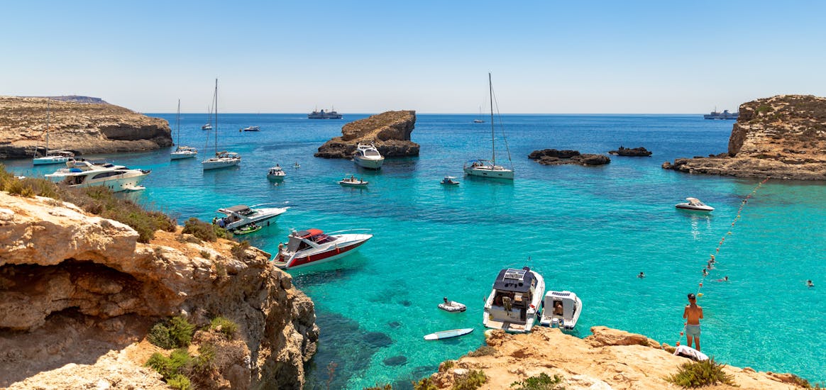 Veel boten zijn aangemeerd bij de kust tijdens de Boottocht naar Comino incl. Blue Lagoon, Caves & St. Paul's Island mit Mermaid Cruises Malta.