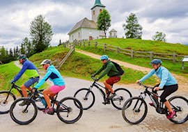 A group of friends is enjoying the scenery during a Relaxed Guided Bike Tour in Upper Savinja Valley with Funpark Menina.