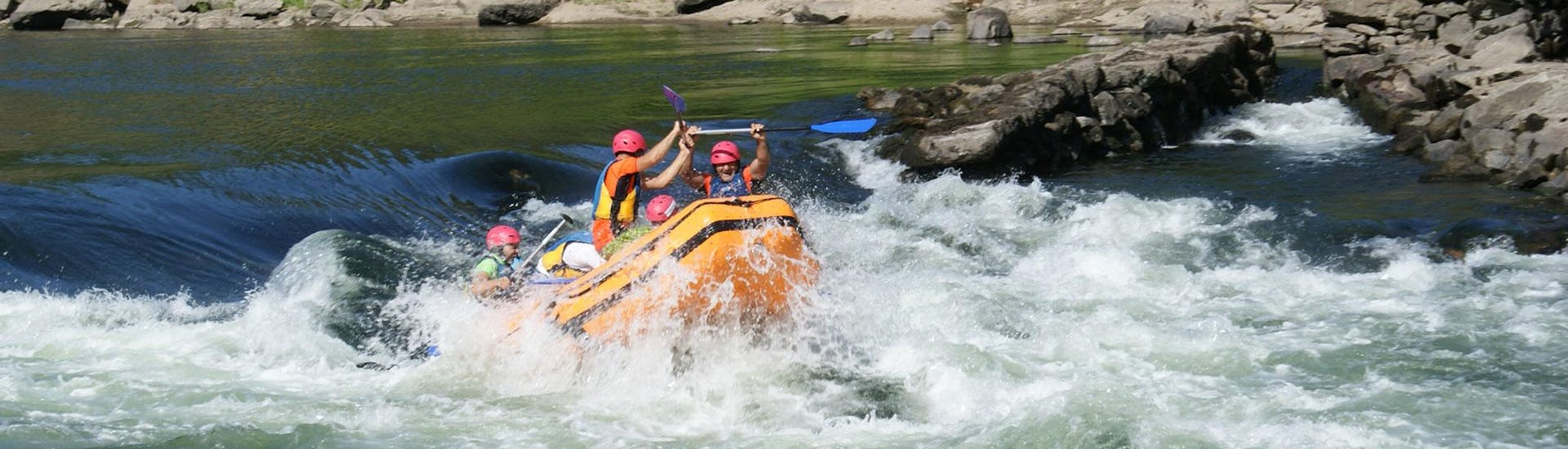A group of people is seemingly enjoying the thrill of rafting on the Minho River with Melgaço White Water.