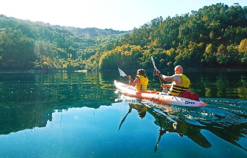 A woman and a man can be seen kajaking in the Peneda-Gerês National Park with Oporto Adventure Tours.