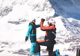 Two children enjoy learning to ski together with their friends during the Kids Ski Lessons (7-11 y.) for All Levels - Full Day with Evolution Ski School Zermatt.