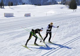 A guide of Langlaufschule Gnadenalm teaches his student the correct technique during the Trial Cross Country Skiing Lessons for All Levels.