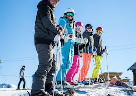 Skiers are standing at the top of a slope ready to start their Adult Ski Lessons for All Levels with the ski school ESI Ski Family in Val Thorens.
