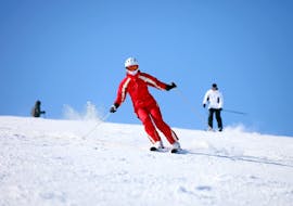 A ski instructor from Skischule Schaber in Grünberg Obsteig is skiing downhill while their pupils follow during one of the Adult Ski Lessons for Beginners.
