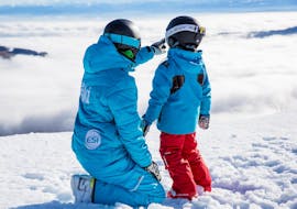 A ski instructor from the ski school ESI Ski Family in Val Thorens is showing a young skier the slope they are going to ski on during their Private Ski Lessons for Kids of All Levels - Morning.