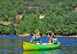 A girl is paddling with her boyfriend on the Dordogne river during the route  from La Roque-Gageac 9km of Canoe Dordogne.