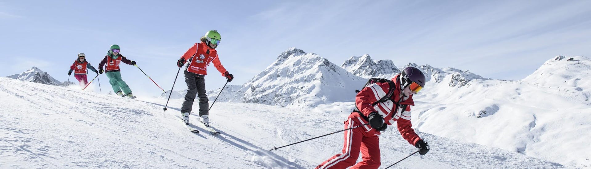 During their Kids Ski Lessons (from 5 y.) for Skiers with Experience a group of children is exploring the slopes of Silvretta Montafon alongside their experienced ski instructor from Skischule Schruns.